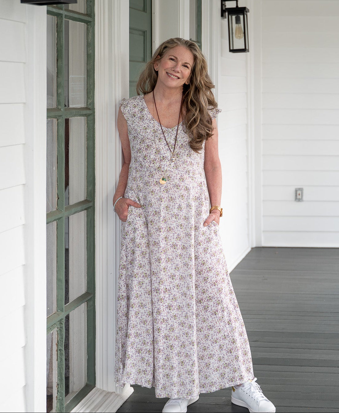 Melissa wearing white sleeveless floral dress
