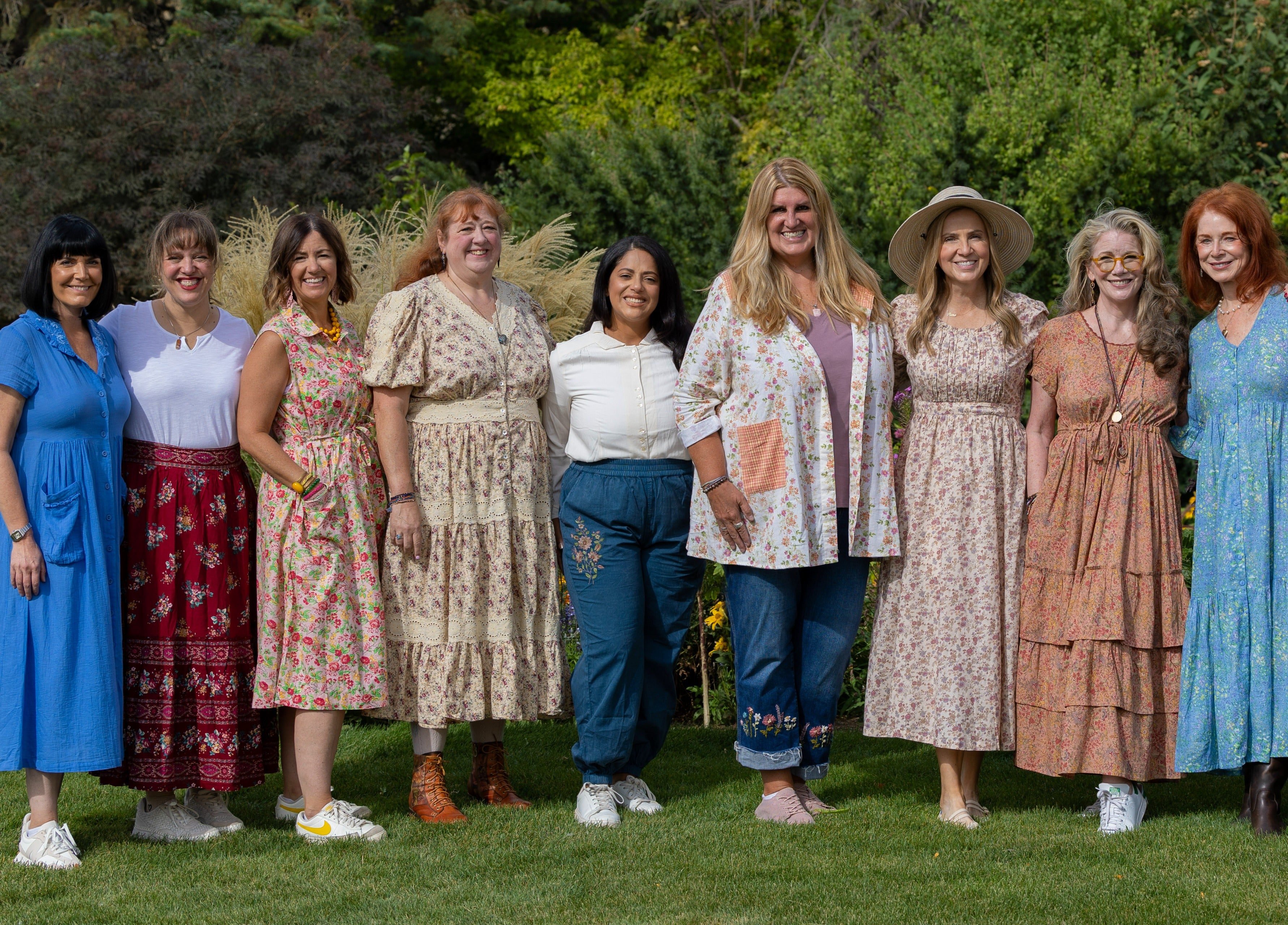 Group of women standing together outdoors in a park-like setting