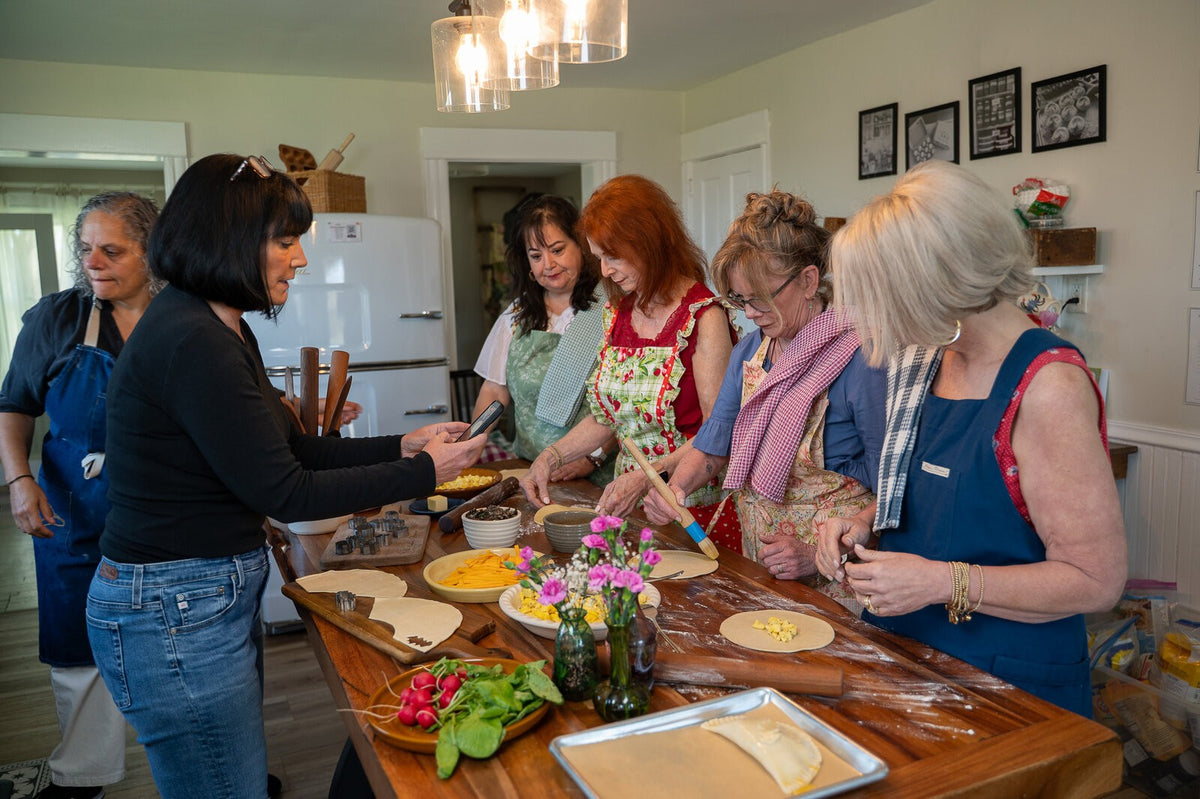 Friends in aprons cooking together in the kitchen