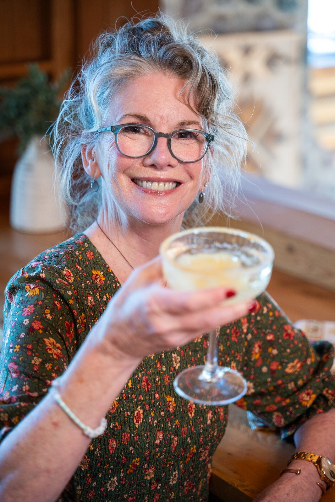 Melissa raising a glass in a toast