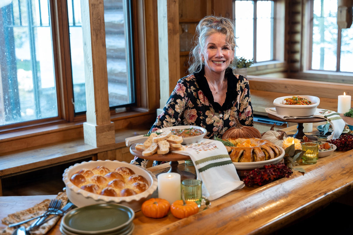 Melissa at a Thanksgiving table filled with sides