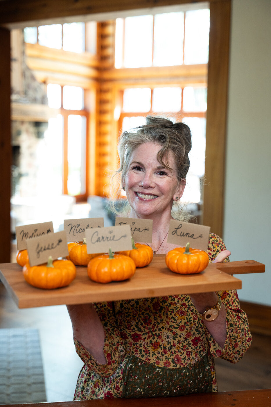 Mini pumpkin place cards on a wooden board